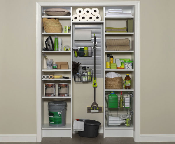 Cleaning supplies organized in hall closet with custom shelving