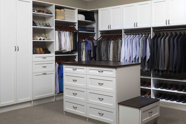 Classic white closet organization system with center island for storage