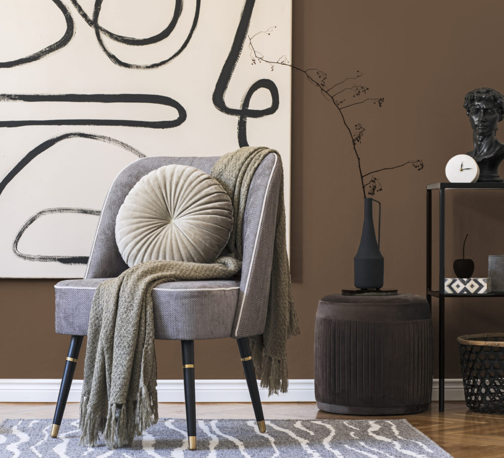 Interior design of living room with stylish gray armchair, abstr